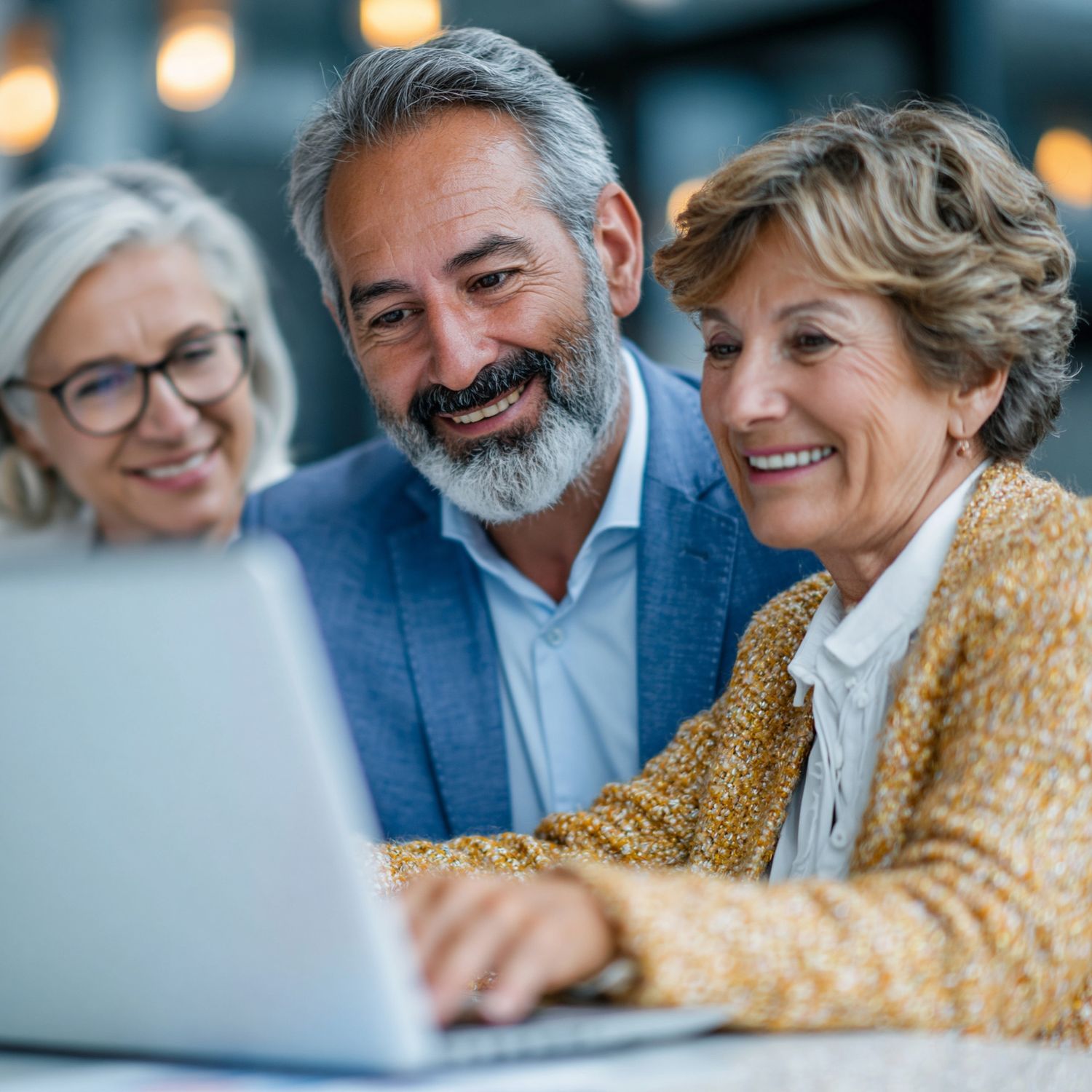 Senior couple working with a friendly specialist at a laptop