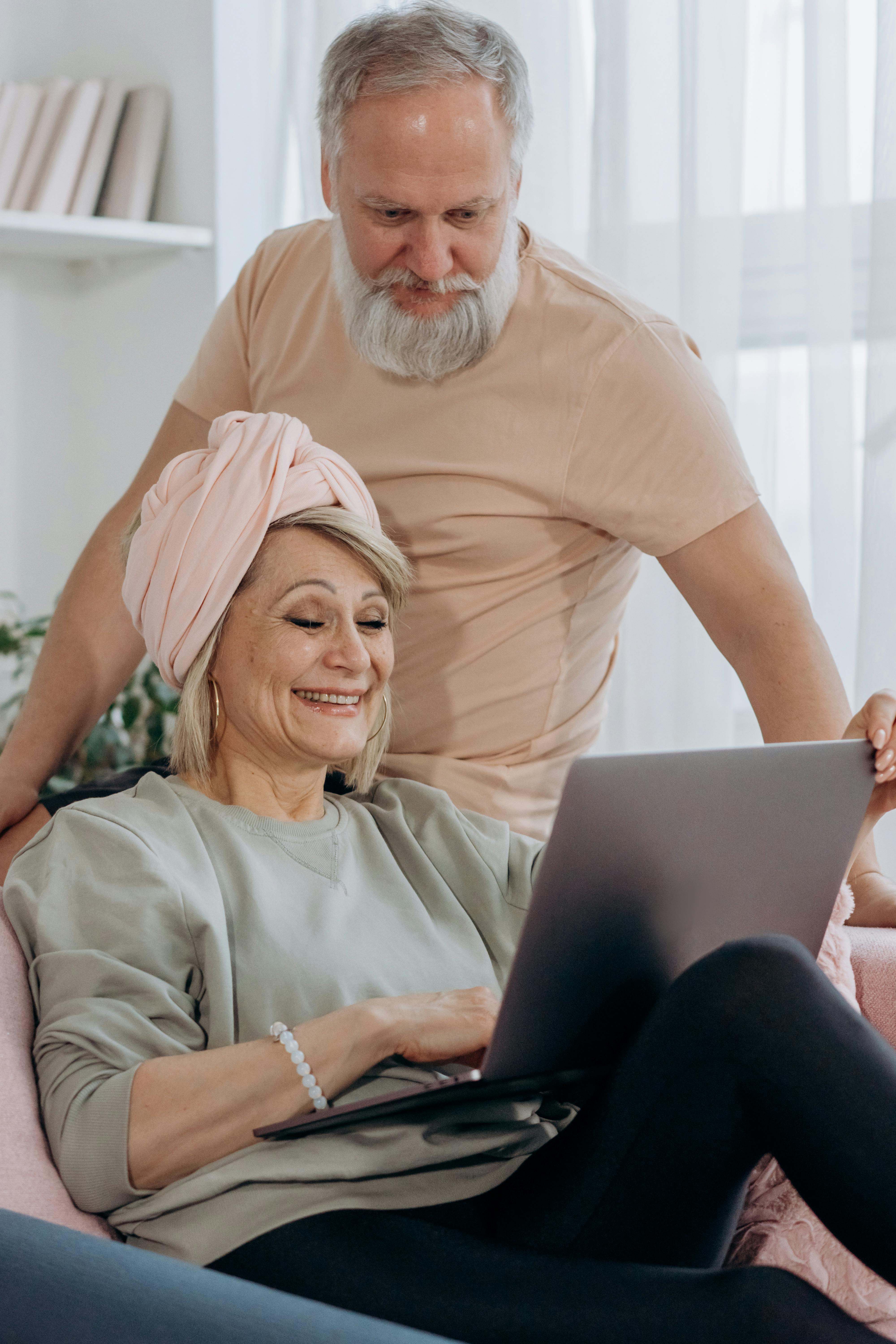 Happy older adults looking at a phone together